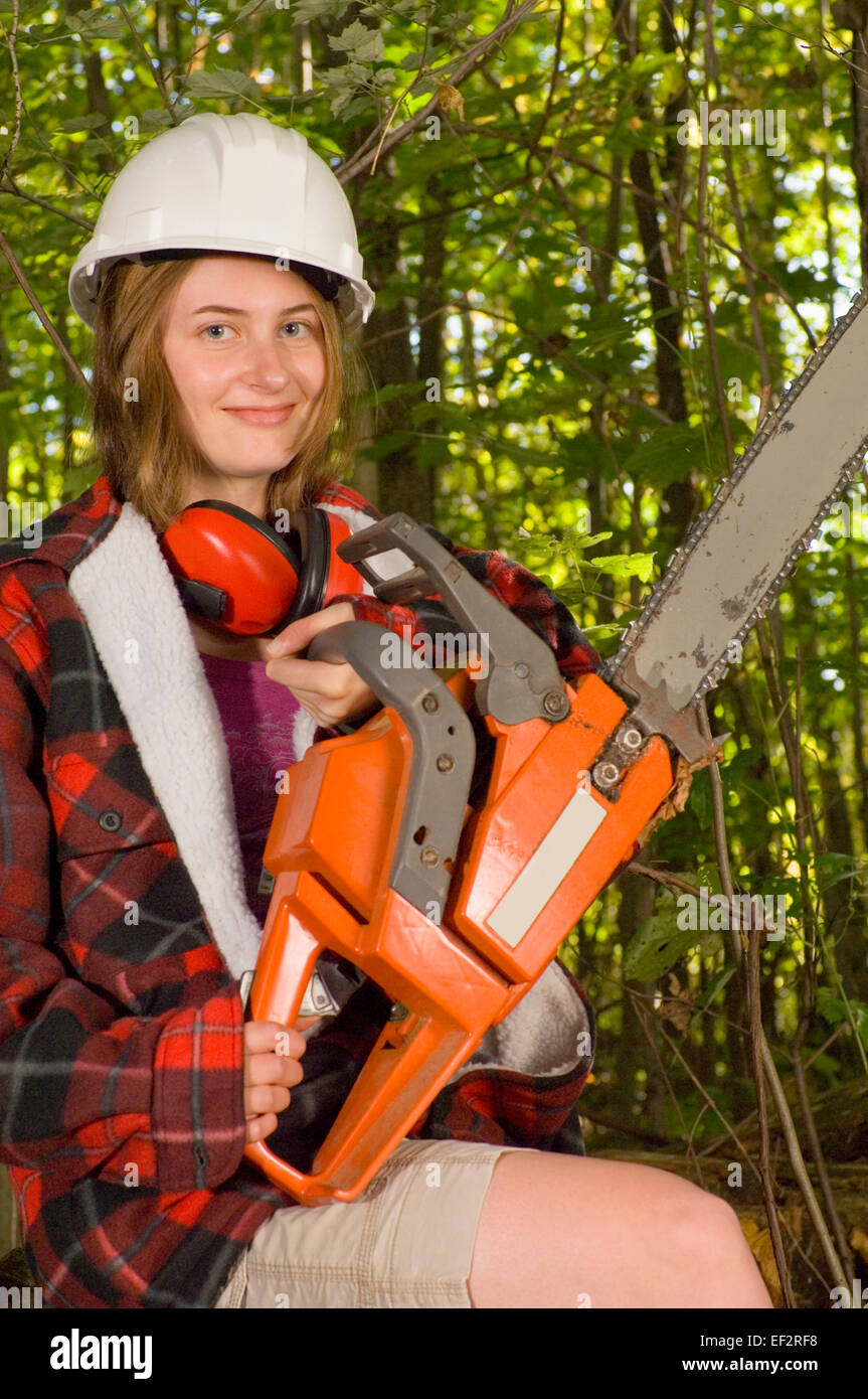 Teenage girl holding a chainsaw Stock Photo Alamy