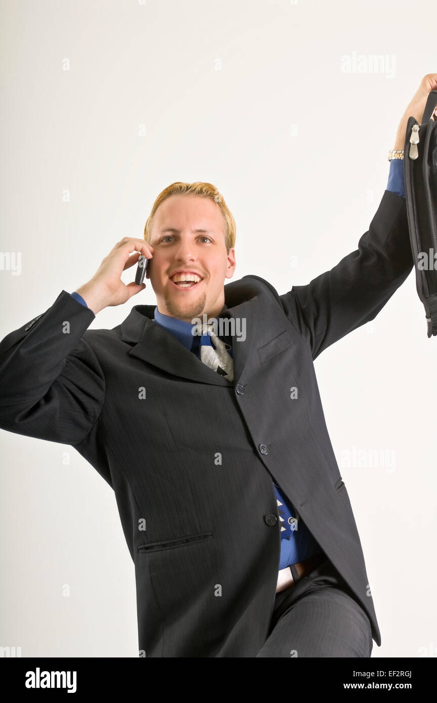 Excited businessman talking on cellular phone Stock Photo