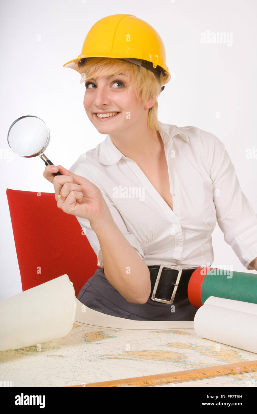 Woman holding magnifying glass while looking at map Stock Photo - Alamy
