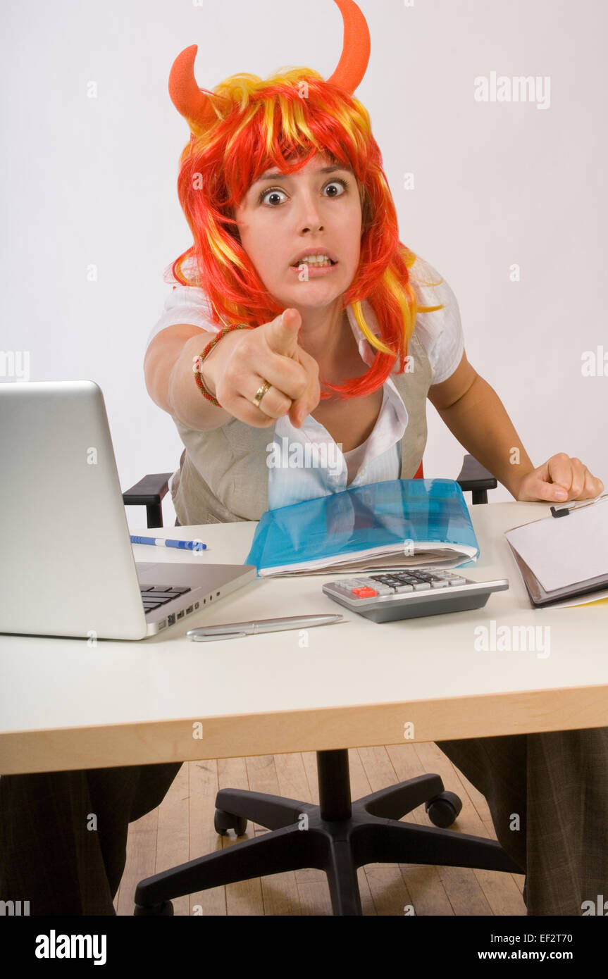 Businesswoman wearing a devil wig Stock Photo
