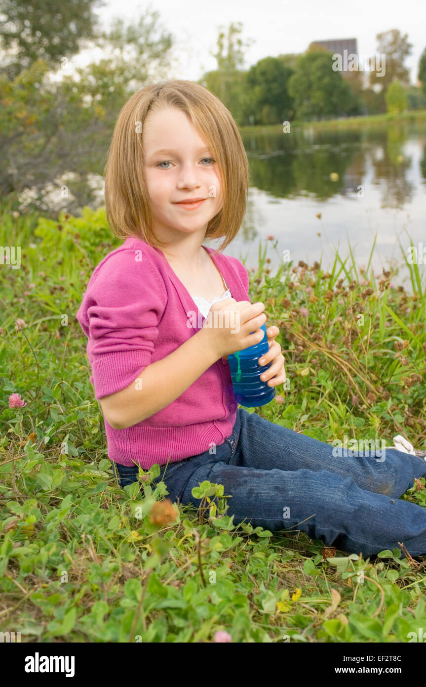 Young girl holding bubble container Stock Photo - Alamy