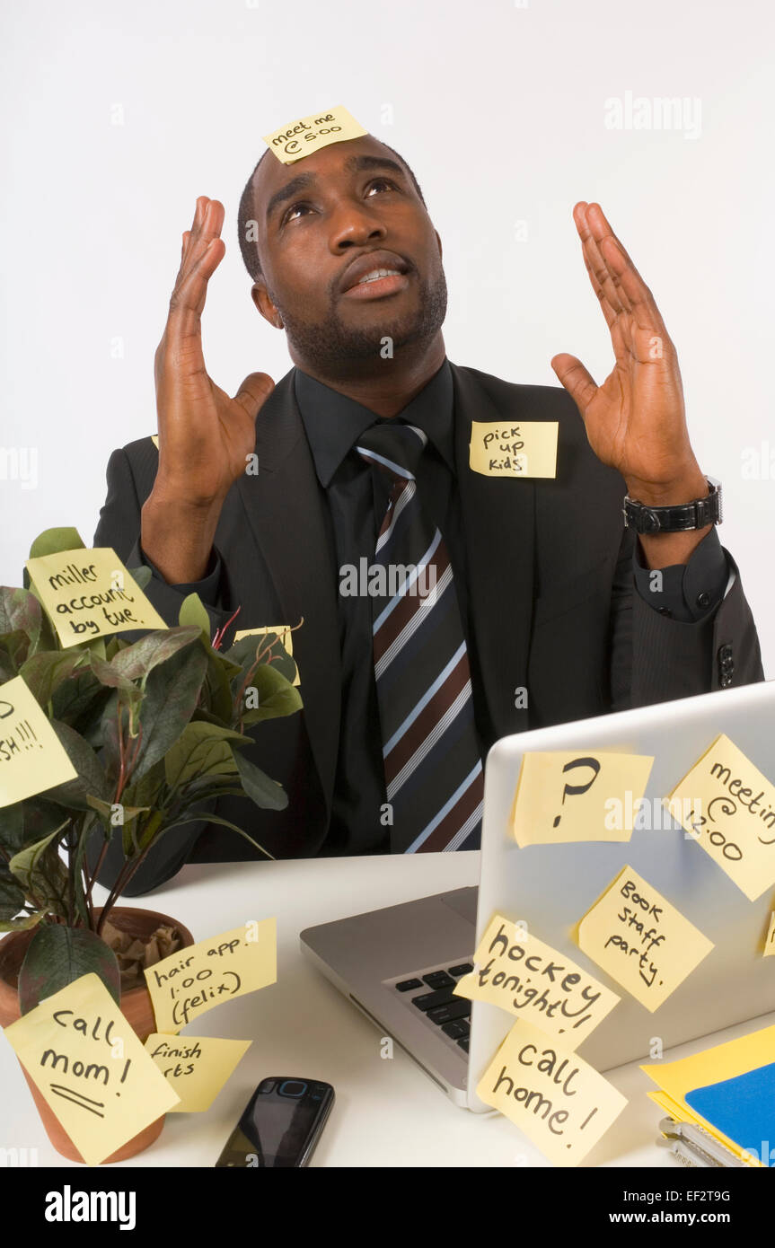Businessman covered in sticky notes Stock Photo