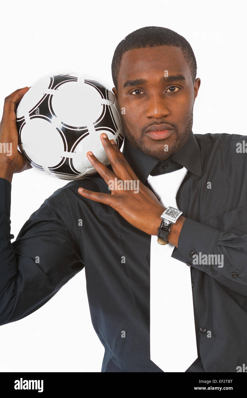 Businessman holding a soccer ball on his shoulder Stock Photo - Alamy