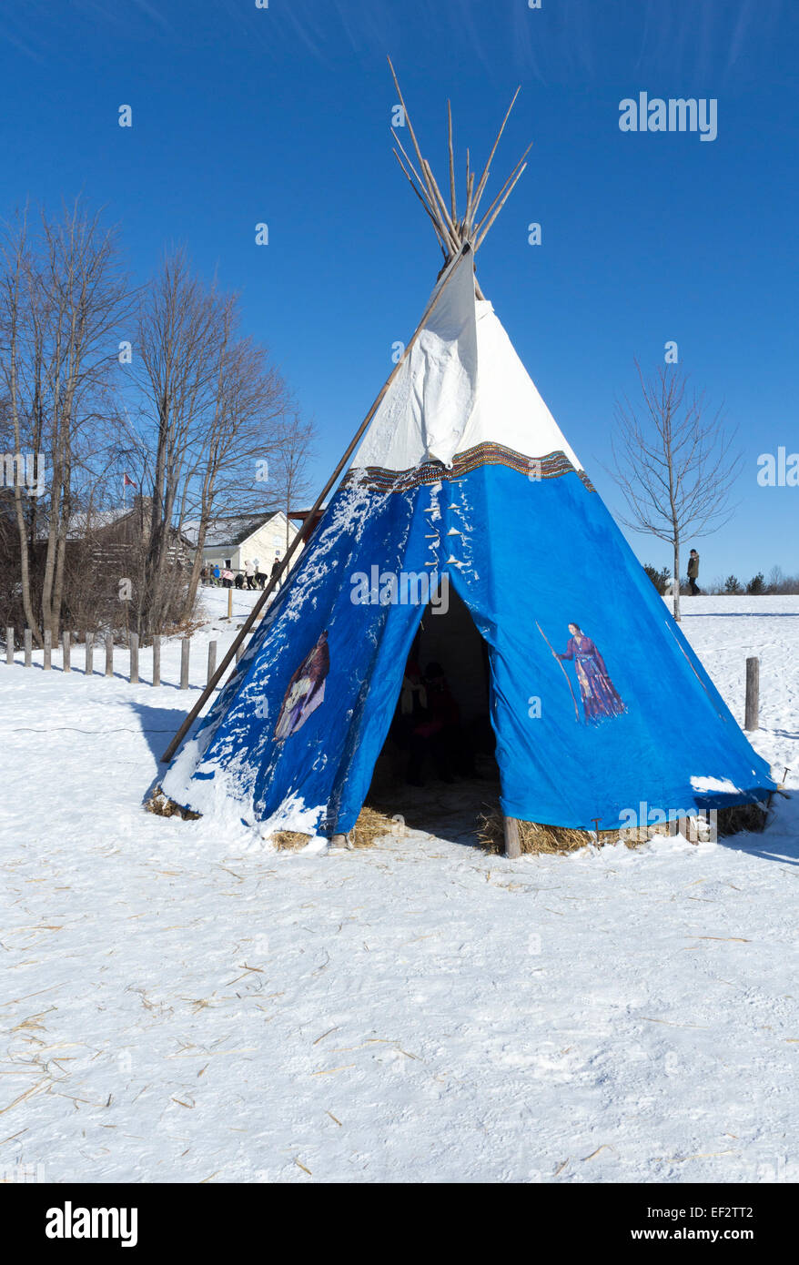 Blue and white Metis teepee with painted portraits on the site at the Cannington Winter Festival . Stock Photo