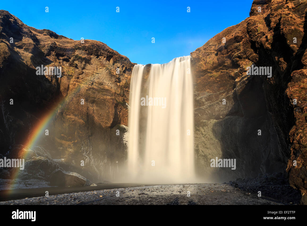 Rainbow in front of Skogafoss Waterfall in southern Iceland Stock Photo