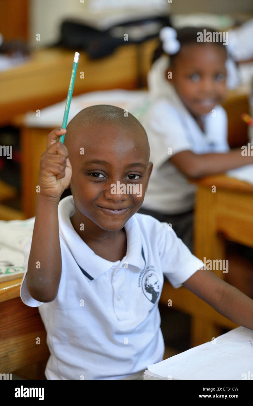 Schoolboy raising his hand in class, class at the Basile Moreau Primary School, Carrefour, Port-au-Prince, Ouest Department Stock Photo