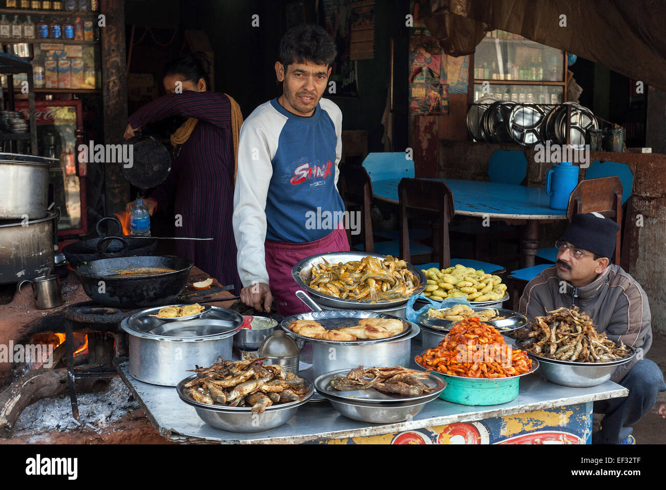 Nepalese restaurant with cooker and displayed food, Mugling, Nepal Stock Photo
