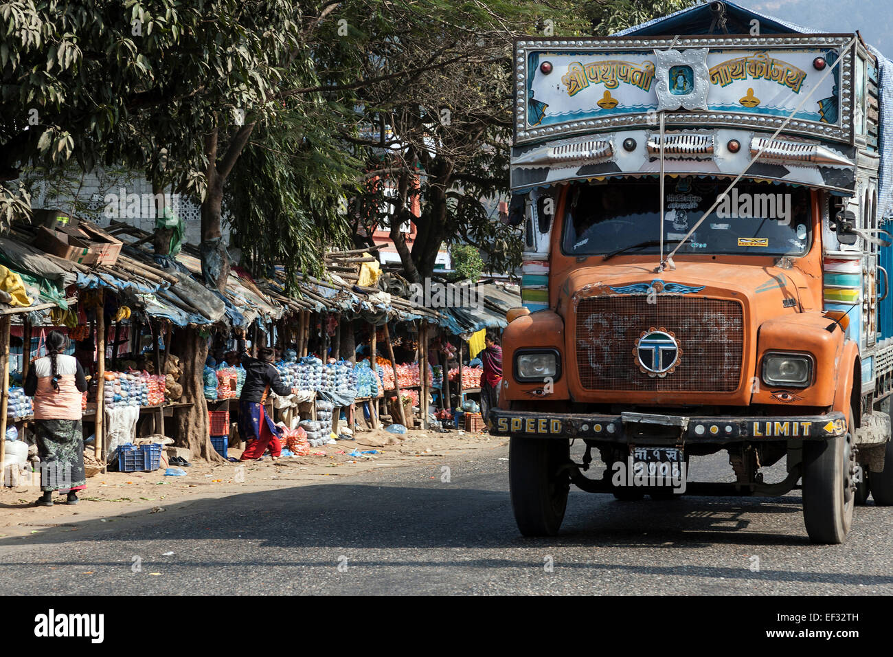 Street scene, Nepalese trucks and market stalls, left, Patauri, Nepal Stock Photo