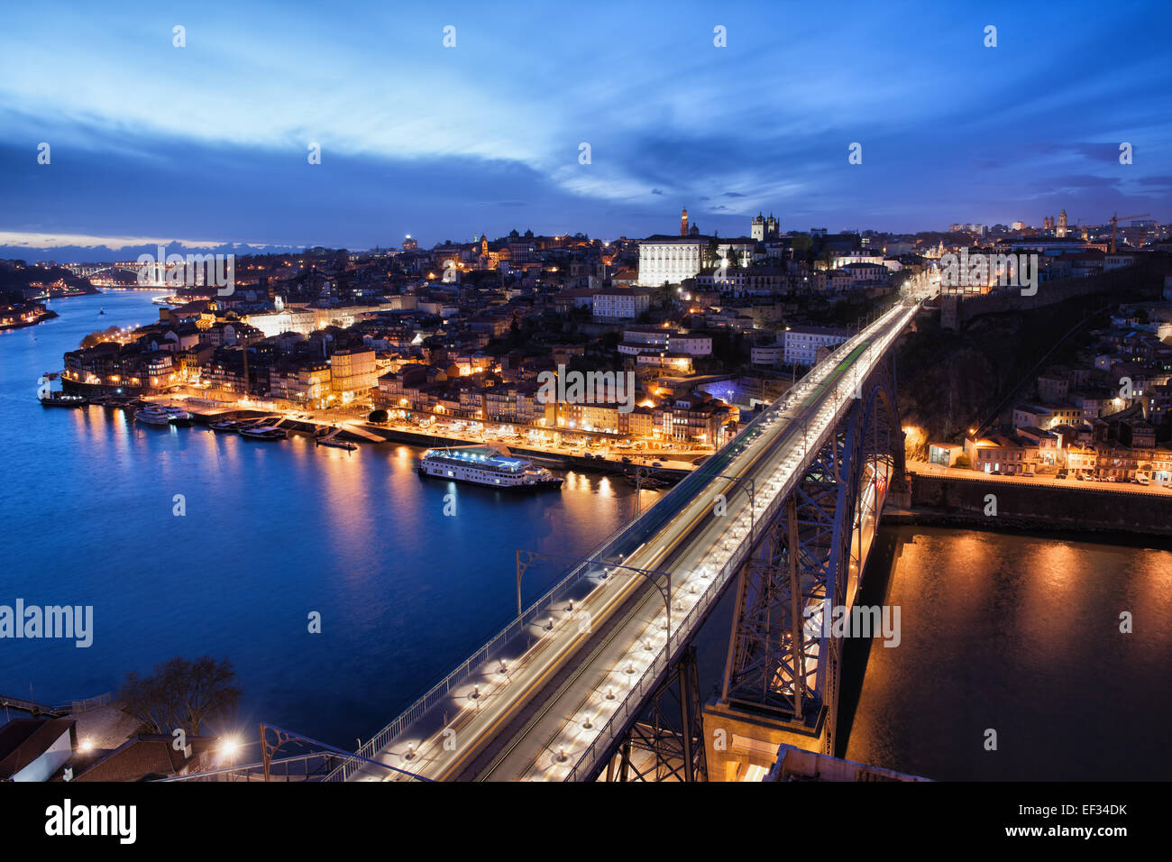 City of Porto at night in Portugal and Dom Luis I Bridge over Douro river. Stock Photo