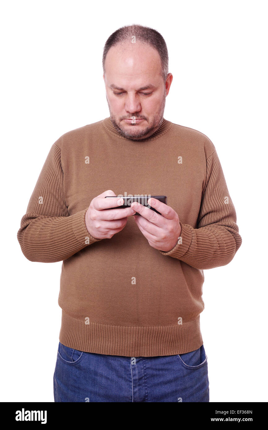 middle aged man looking down at his mobile smart phone Stock Photo