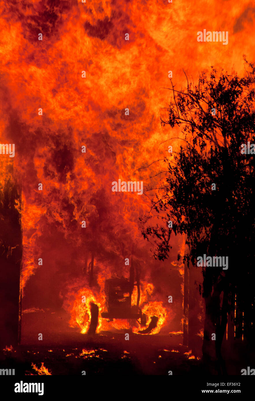 A burning tractor in a field, a dramatic scene capturing the ...