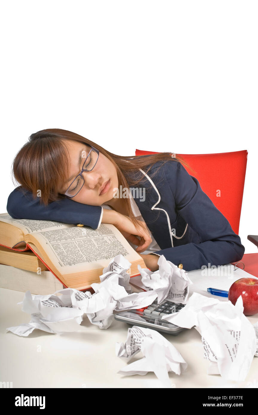 Teenage student sleeping at her desk Stock Photo
