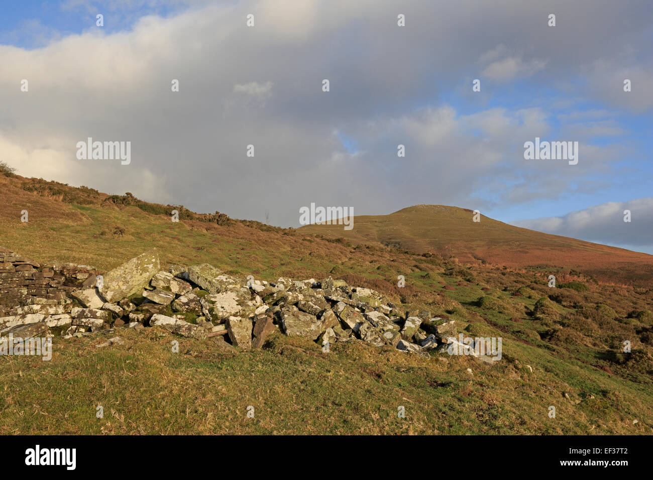 View looking up to the top of sugar loaf mountain with ruined house in the foreground Stock Photo