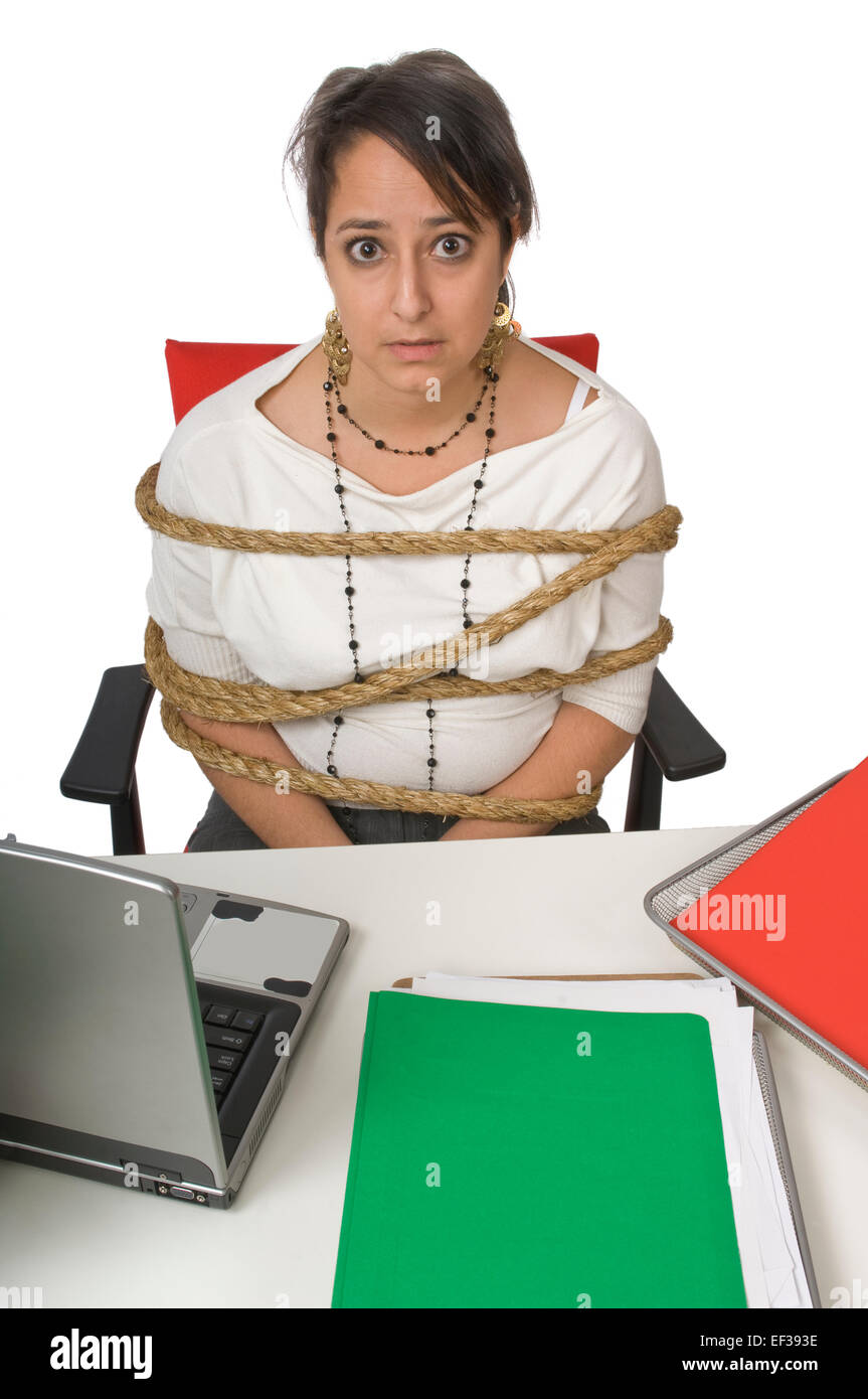 Businesswoman all tied up at her desk Stock Photo