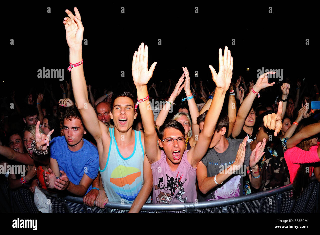 BENICASSIM, SPAIN - JULY 20: Fans watch a concert at FIB Festival on July 20, 2014 in Benicassim, Spain. Stock Photo