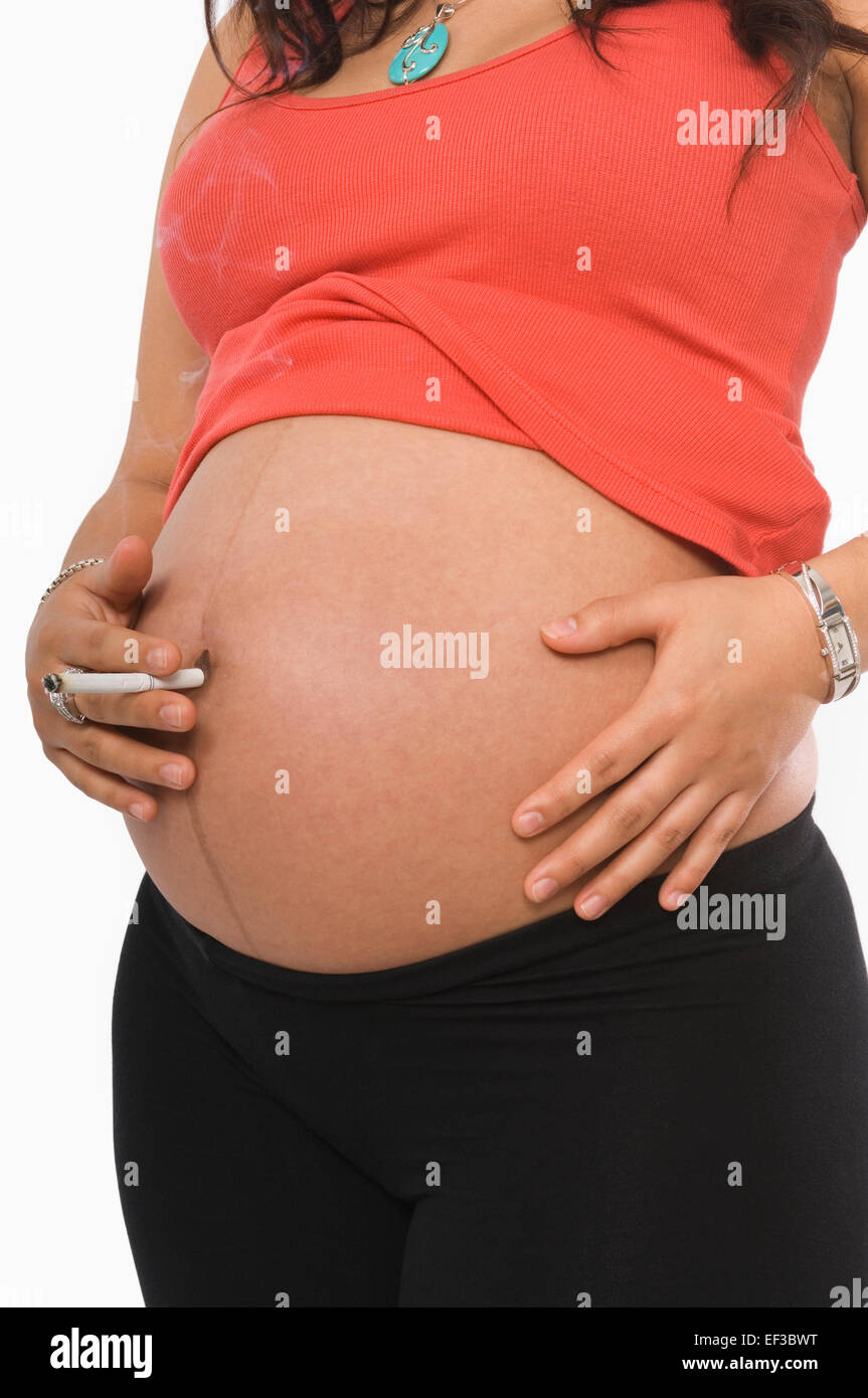 Cigarette in belly button hi-res stock photography and images