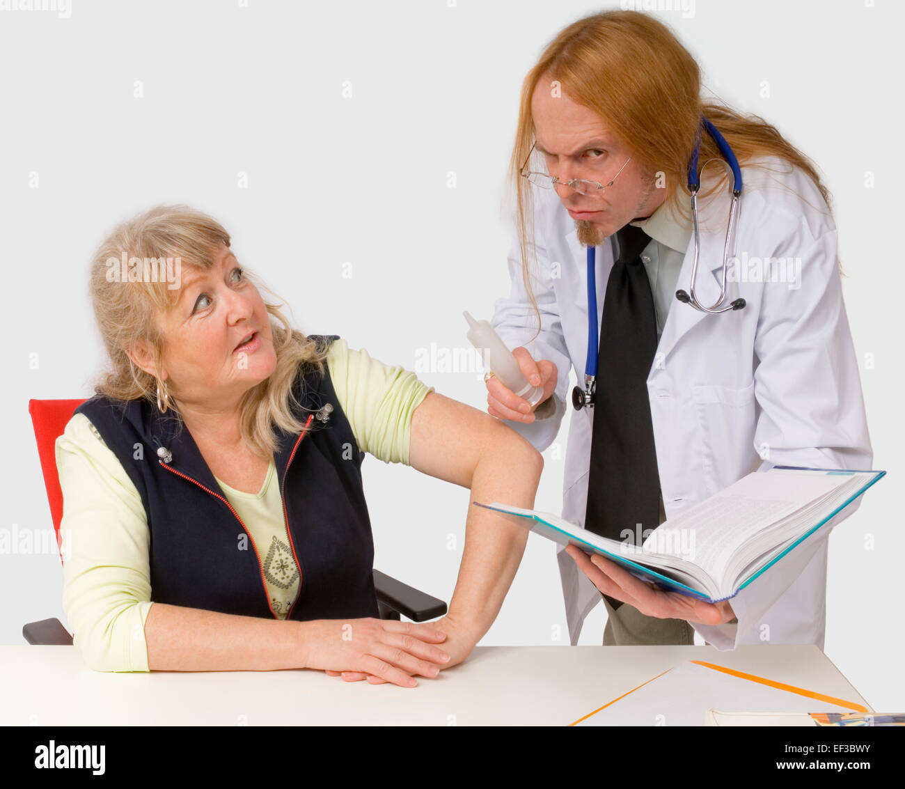 Apprehensive woman looking at Doctor Stock Photo