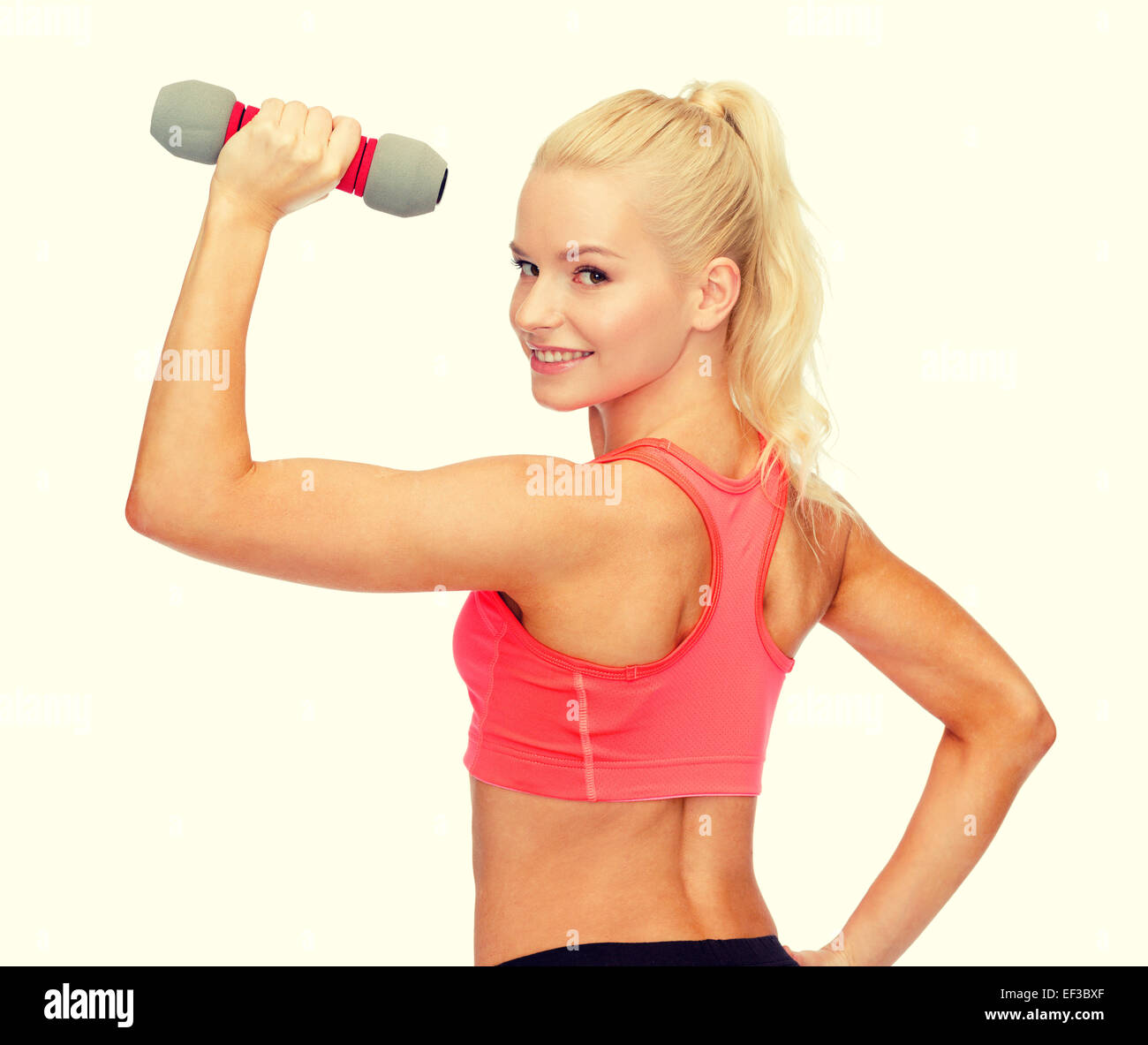 young sporty woman with light dumbbell Stock Photo