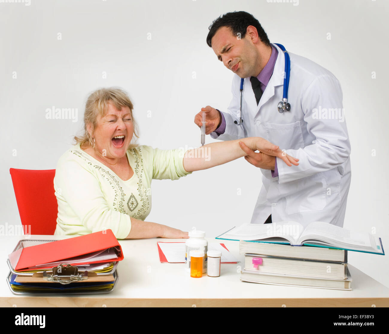 Doctor giving patient a painful needle Stock Photo Alamy