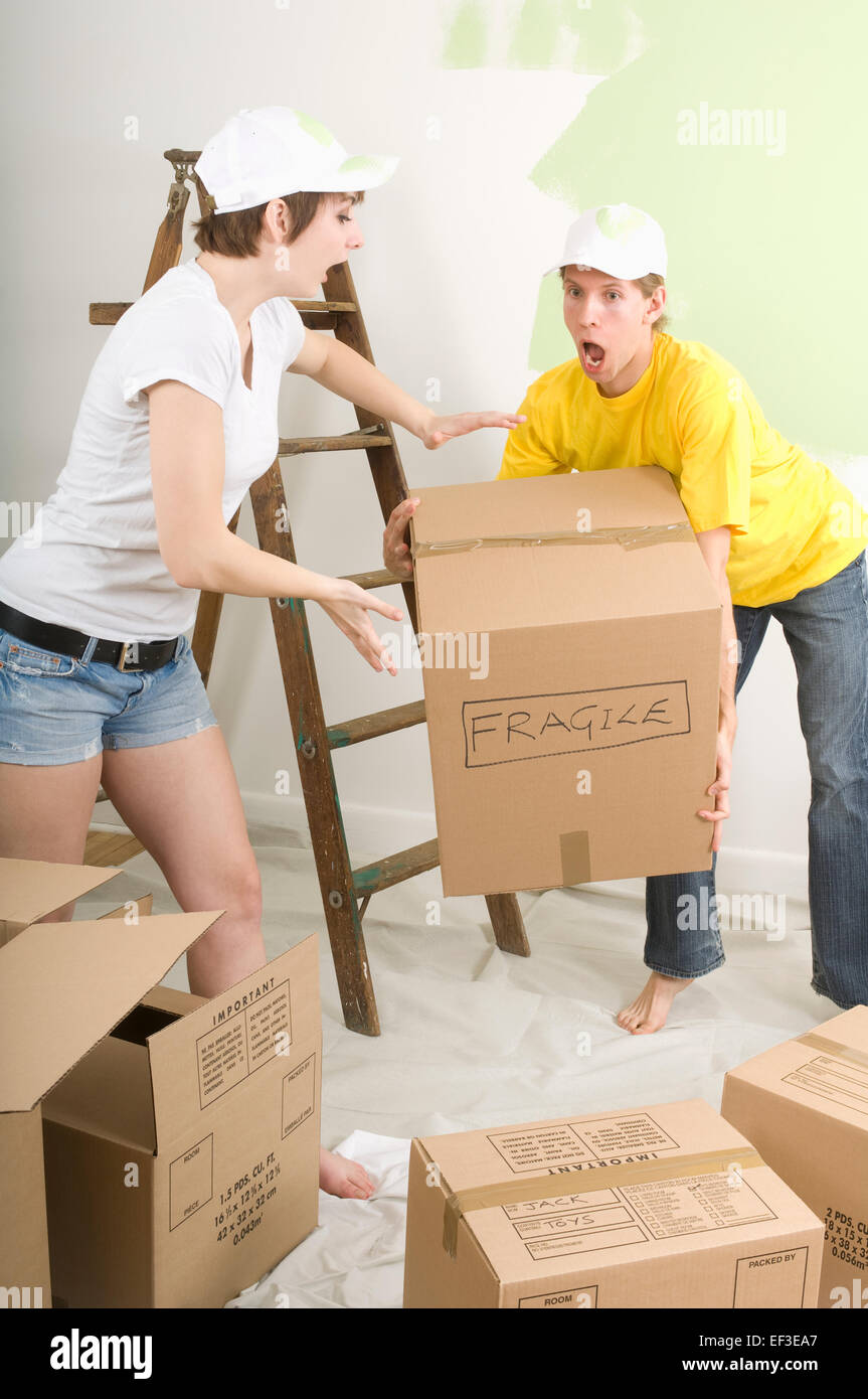 Man about to drop a box marked fragile Stock Photo