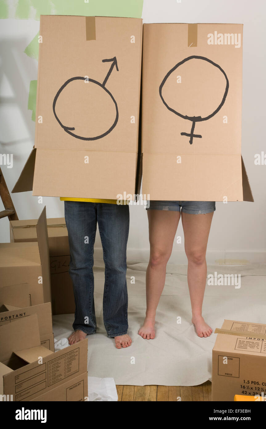 Couple inside boxes marked with male and female symbols Stock Photo