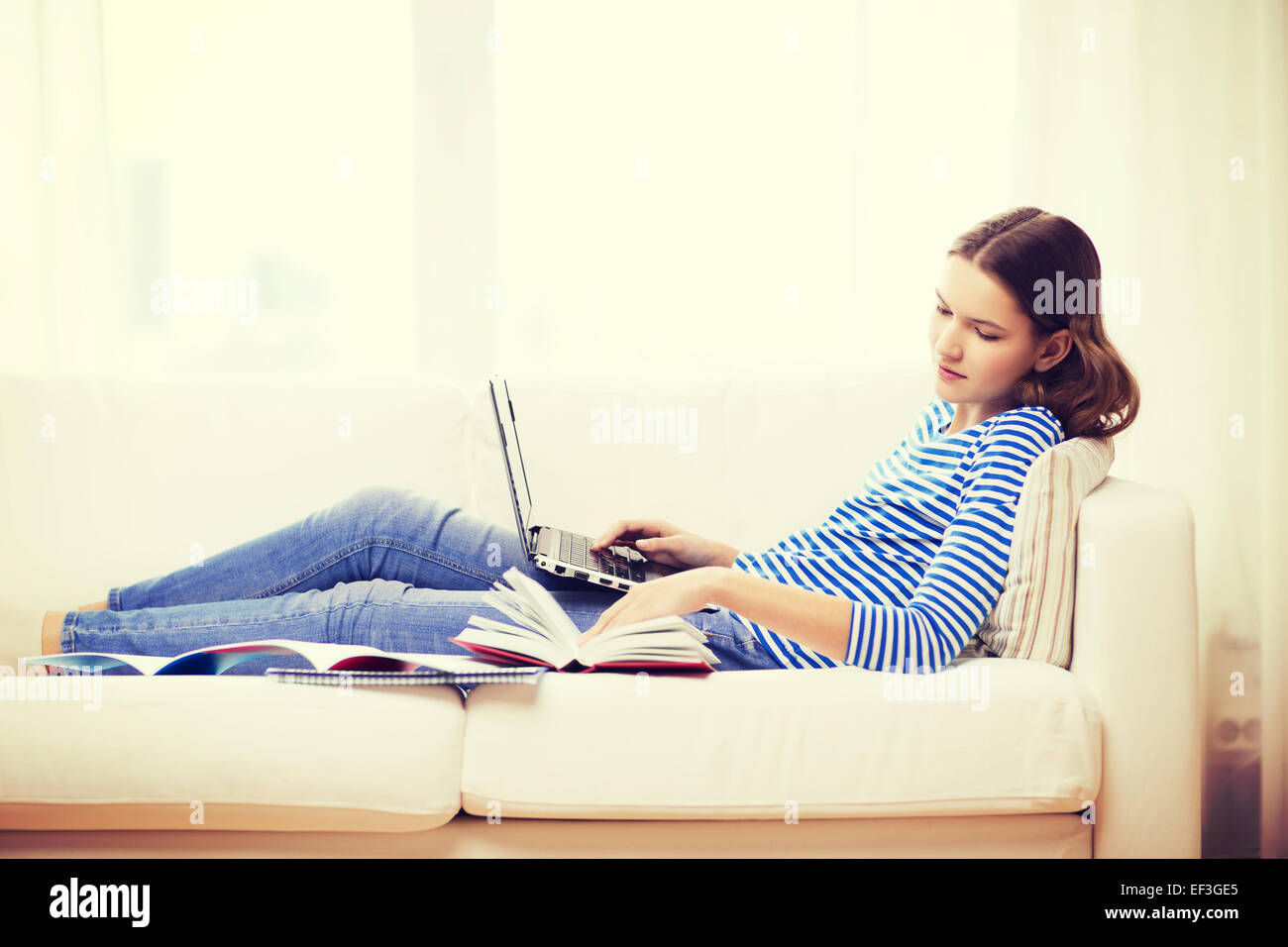 smiling teenage girl with laptop computer at home Stock Photo - Alamy