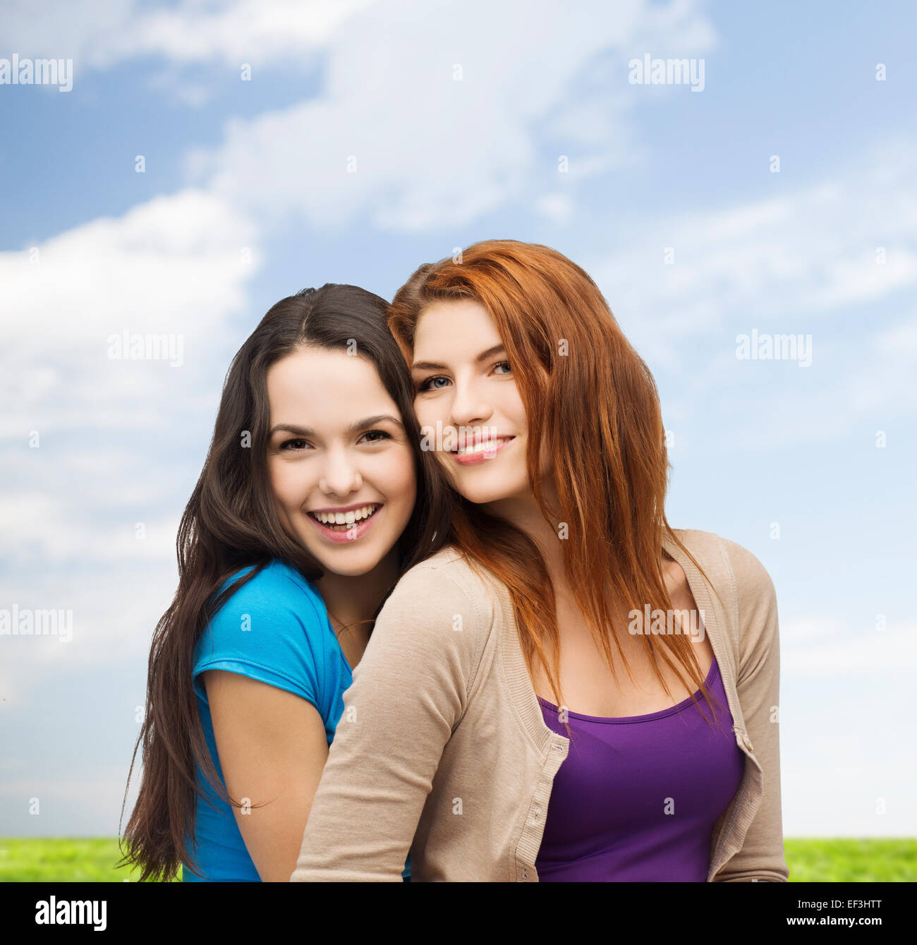 smiling teenage girls hugging Stock Photo - Alamy