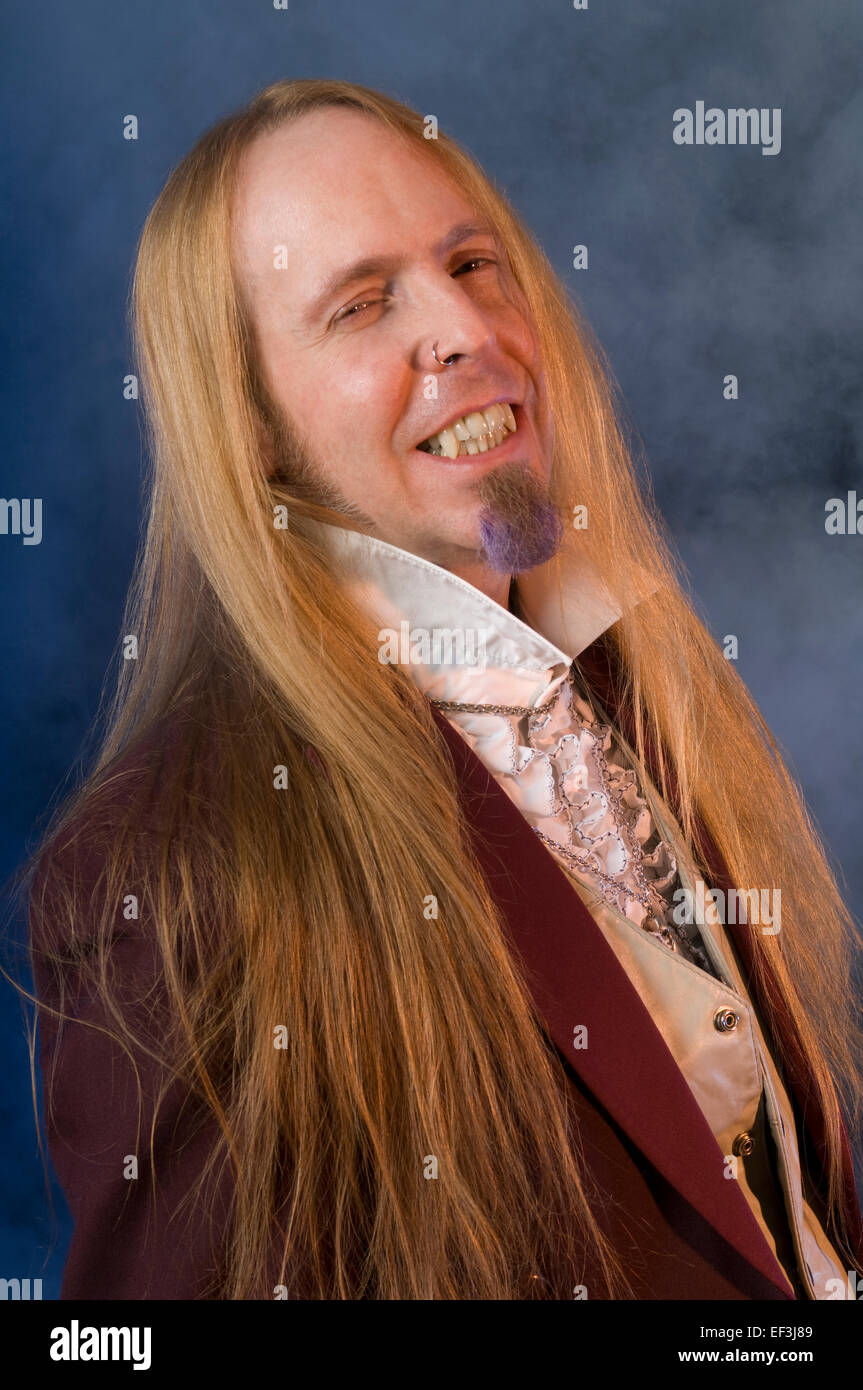 Man with long hair and a purple goatee Stock Photo