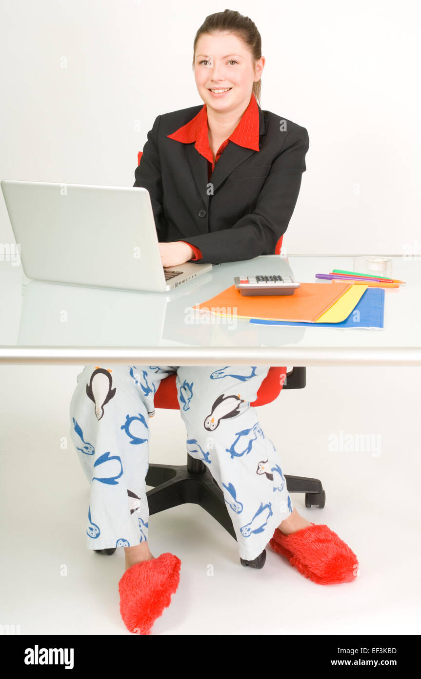 Businesswoman wearing pajama bottoms and slippers Stock Photo