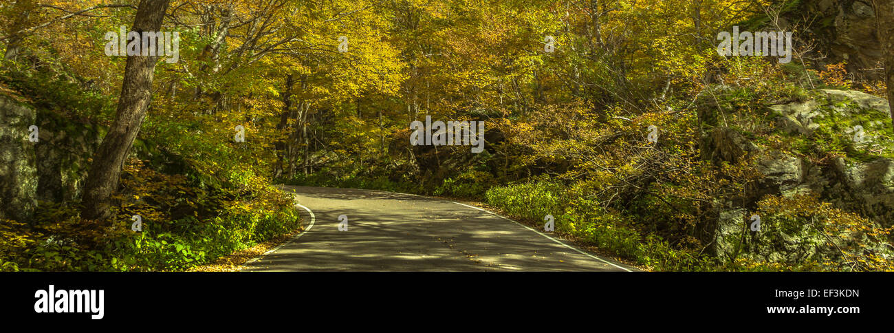 Autumnal Road - A shot of the road that goes through Smugglers Notch near Stowe in Vermont Stock Photo
