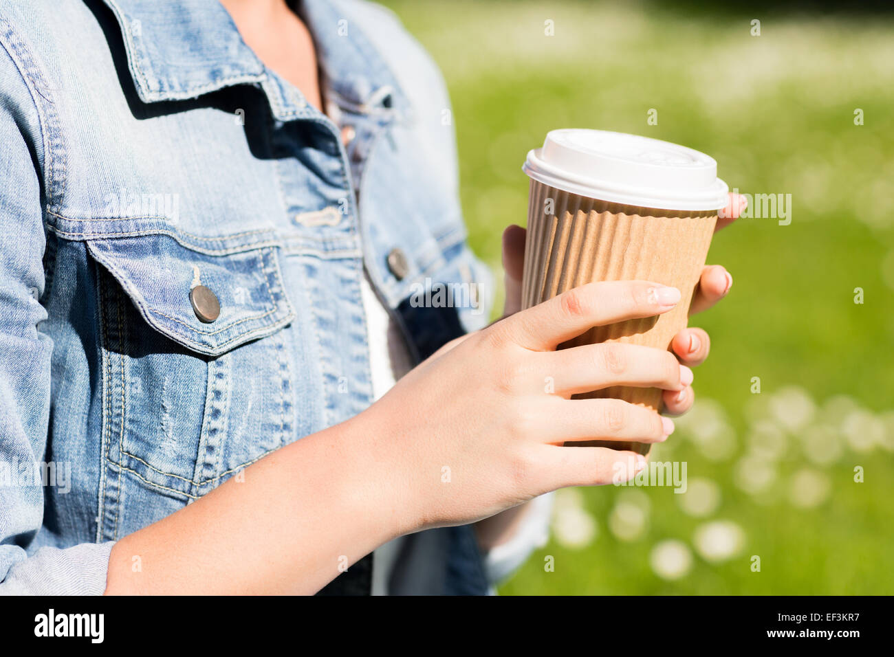 close up of young girl with coffee cup outdoors Stock Photo