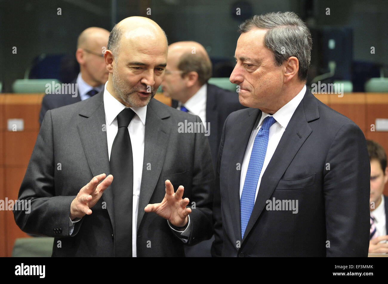 (150126) -- BRUSSELS, Jan. 26, 2015 (Xinhua) -- European Commissioner for Economic and Financial Affairs, Taxation and Customs Pierre Moscovici (L) speaks with European Central Bank (ECB) President Mario Draghi prior to an Eurogroup finance ministers meeting at EU headquarters in Brussels, Belgium, Jan. 26, 2015. (Xinhua/Ye Pingfan) Stock Photo