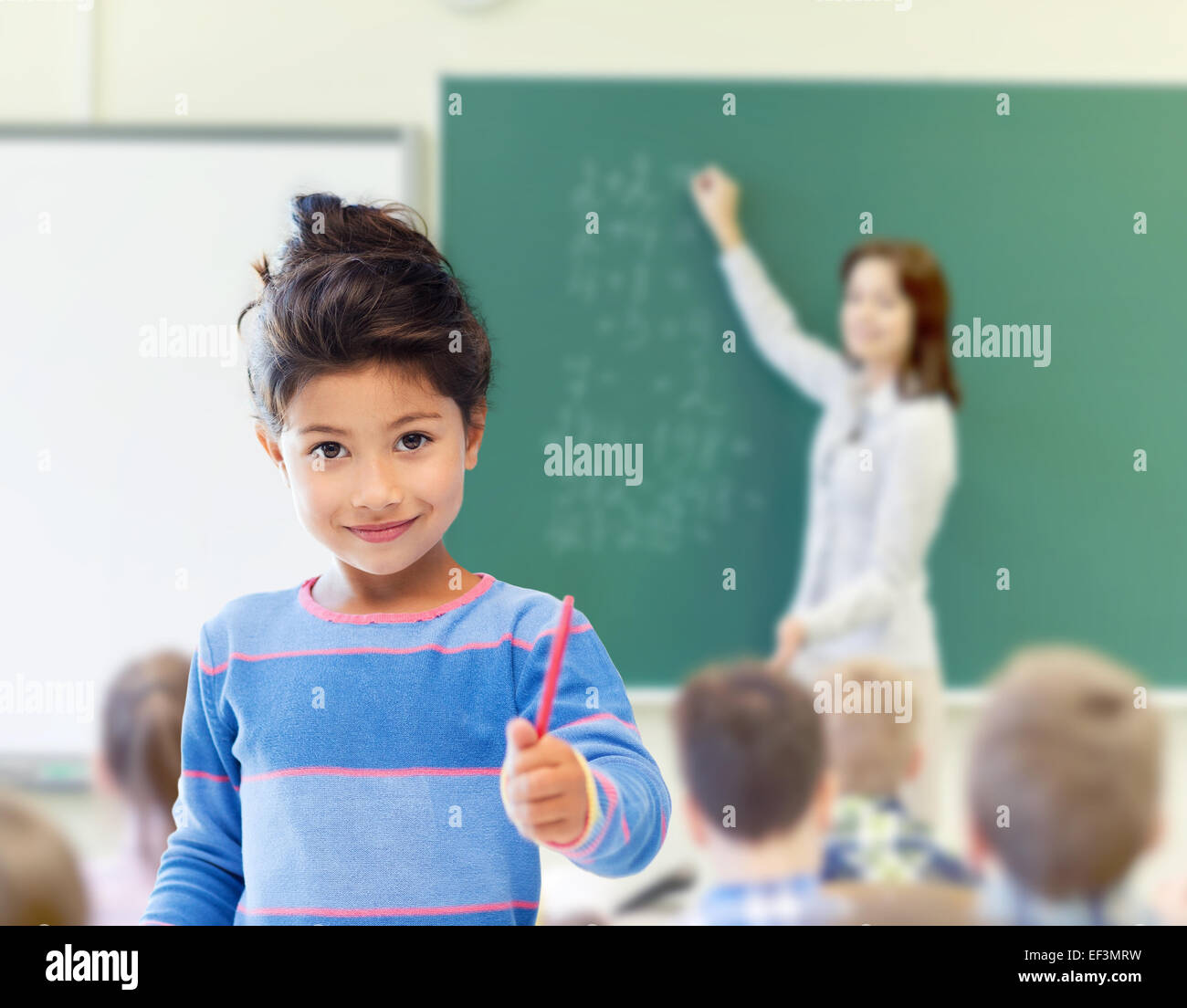happy little school girl over classroom background Stock Photo - Alamy
