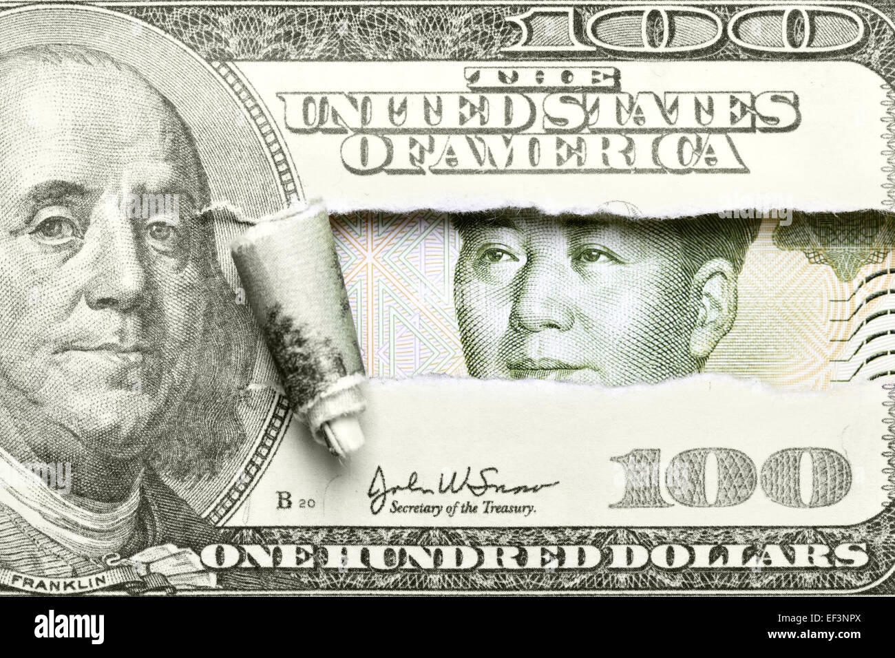 Dollar vs. Yuan - Torn hundred dollar bill with Mao from yuan Stock Photo