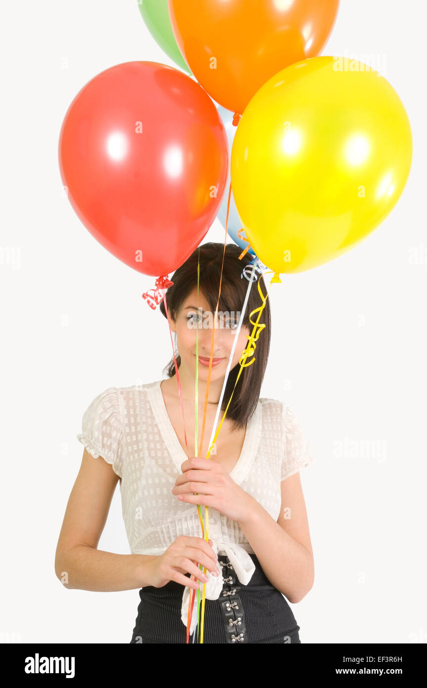 Woman holding balloons Stock Photo