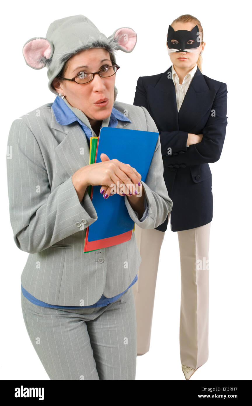 Businesswoman wearing a mouse hat caught by woman wearing cat mask Stock Photo