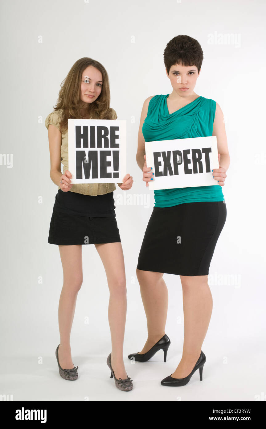 Two unemployed women holding signs Stock Photo