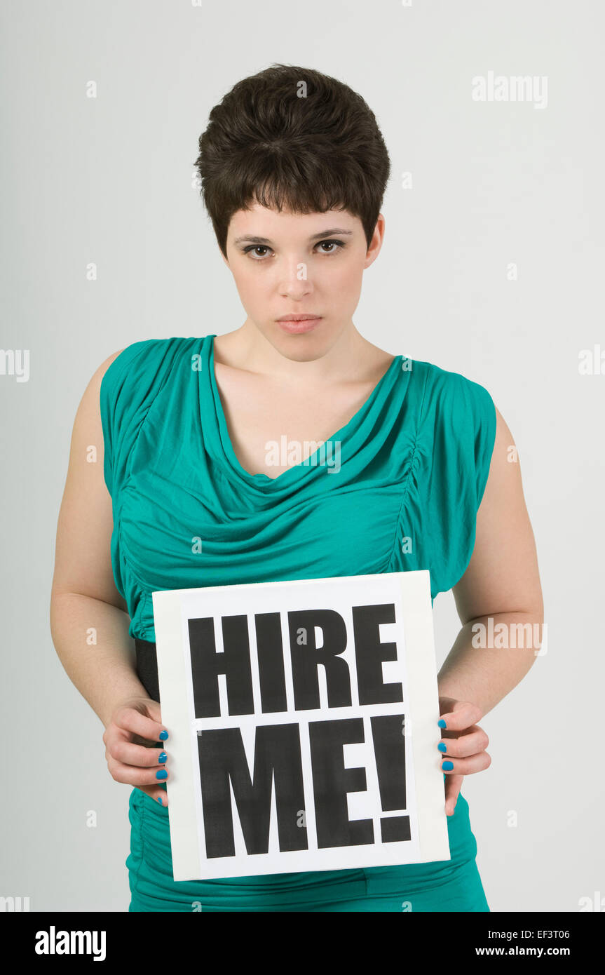 Woman holding a hire me! sign Stock Photo