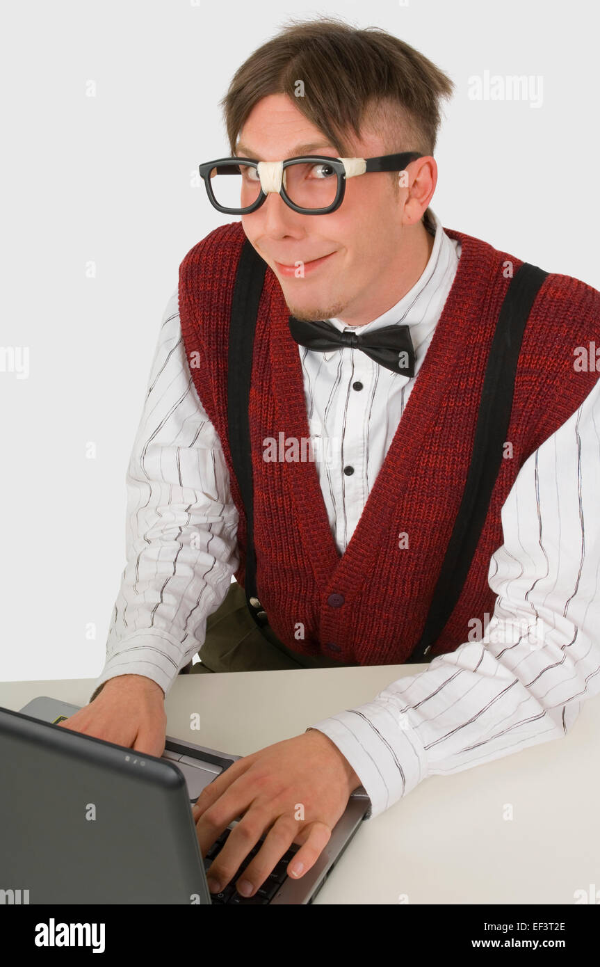 Nerdy looking person working on laptop Stock Photo