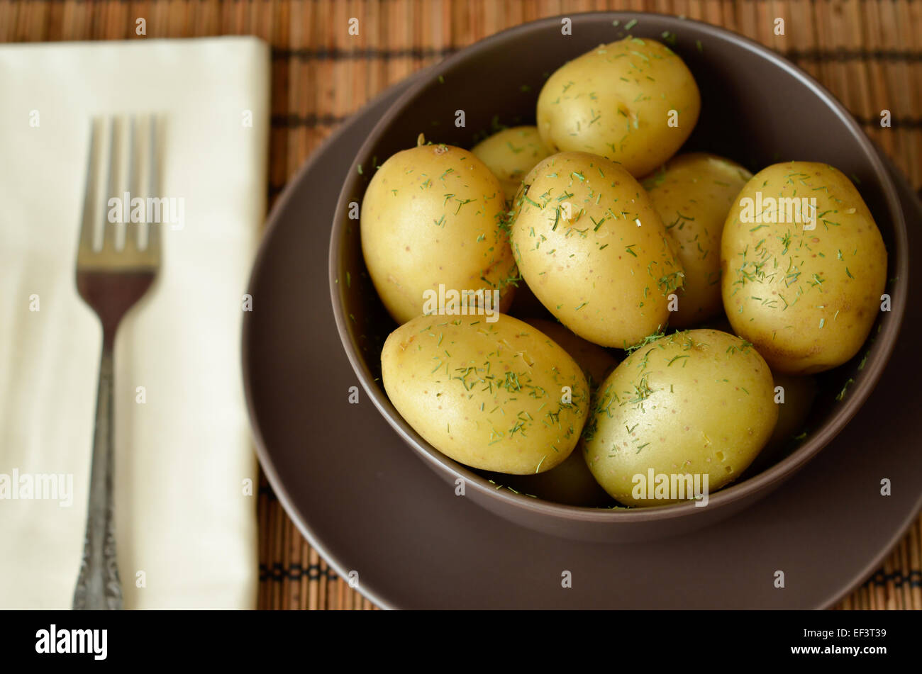Cooked potatoes with dill in a bowl Stock Photo