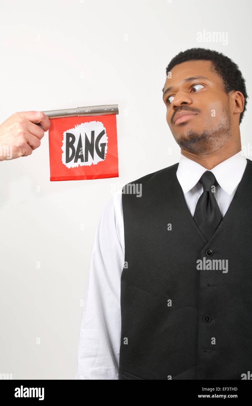 Businessman looking at someone holding a toy gun Stock Photo