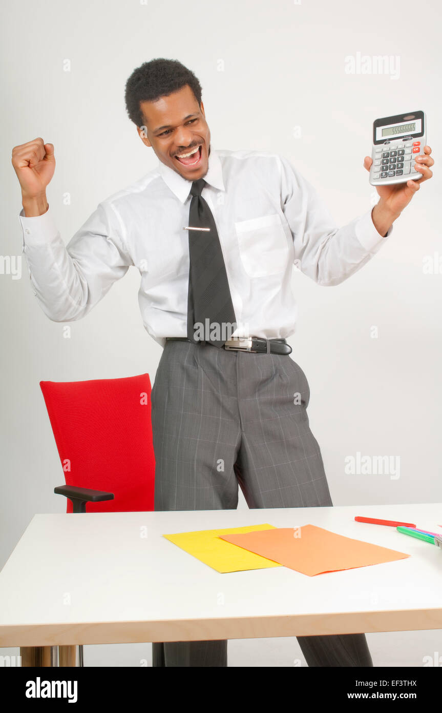 Happy man holding a calculator Stock Photo