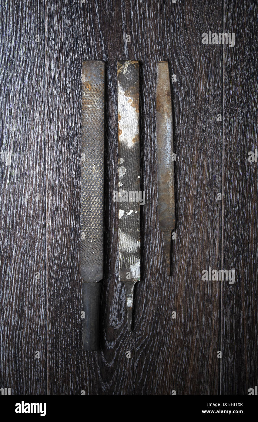 Old Rasps Three old rasps on a wooden surface. Vertical photo Stock Photo - Alamy