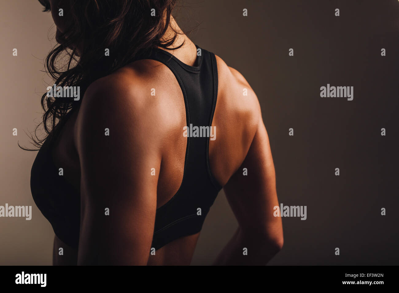 Rear view of strong young woman wearing sports bra. Muscular back of a woman  in sportswear Stock Photo - Alamy