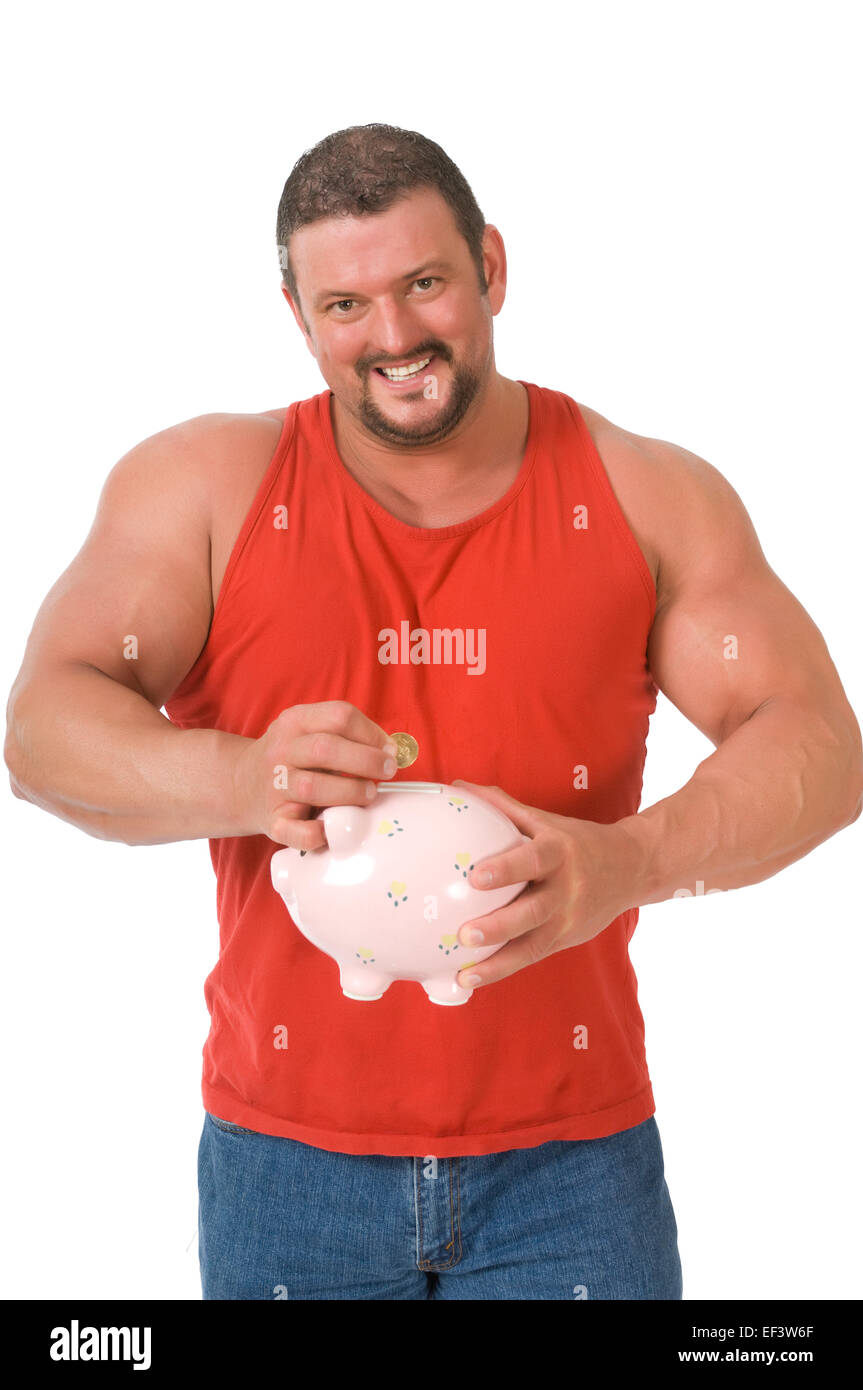 Muscular man putting coin in piggy bank Stock Photo - Alamy