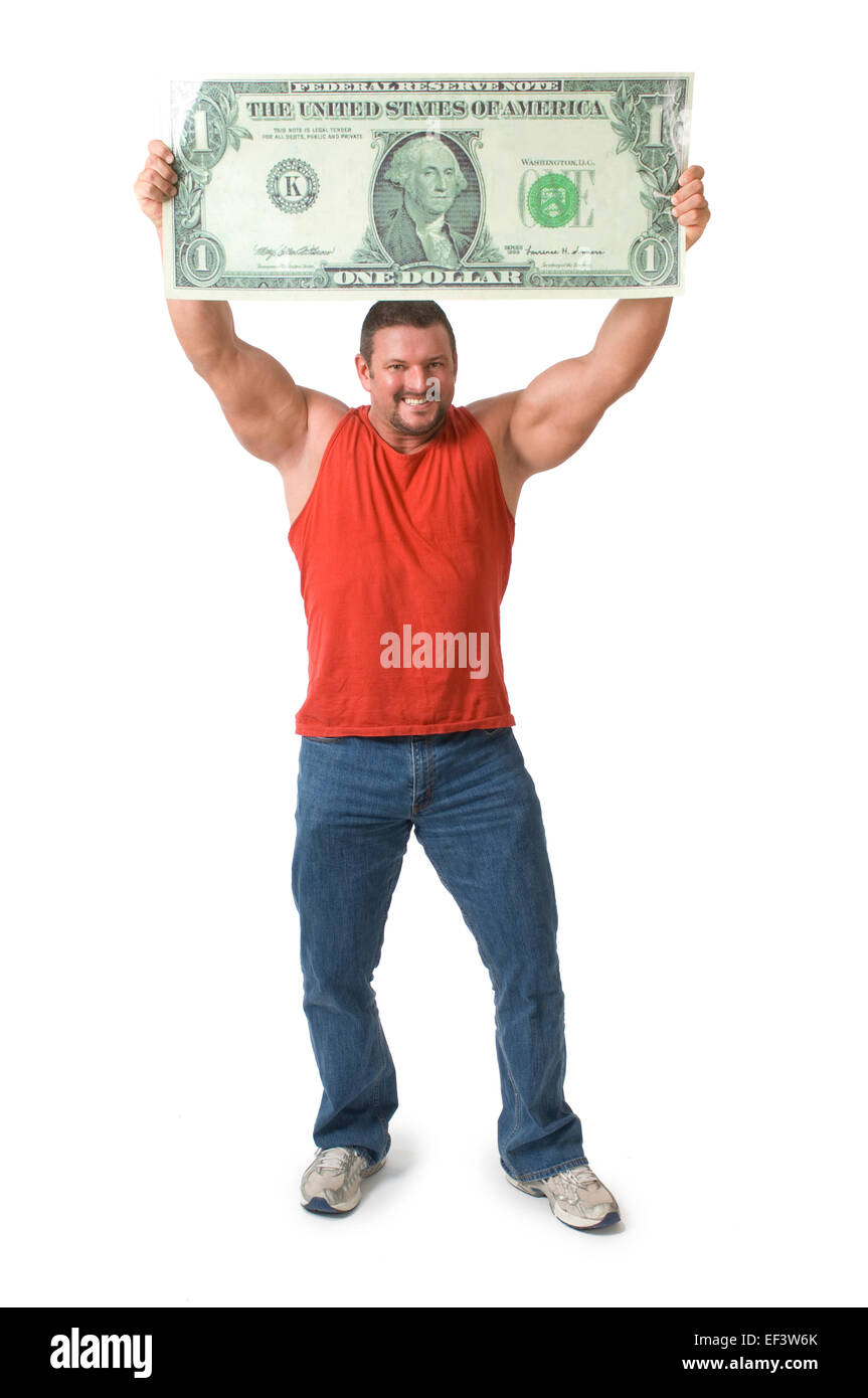 Muscular man holding oversized dollar bill over his head Stock Photo