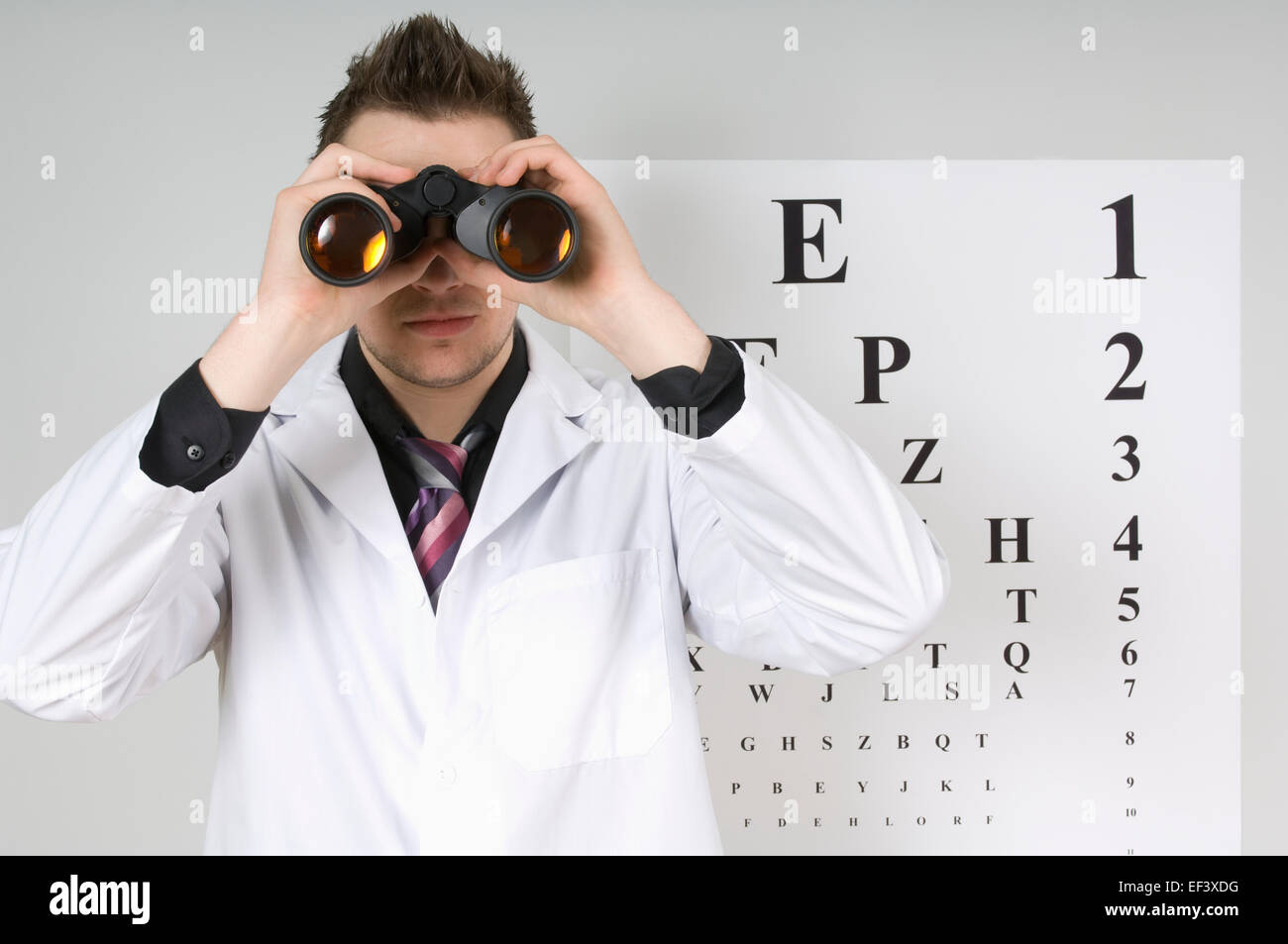 Ophthalmologist looking through binoculars Stock Photo
