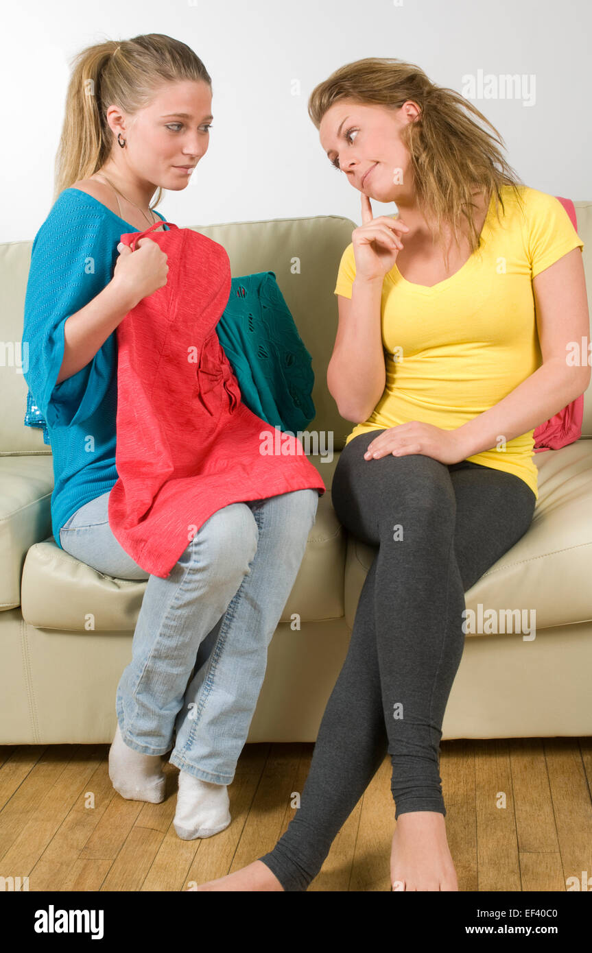 Woman showing her friend a red dress Stock Photo