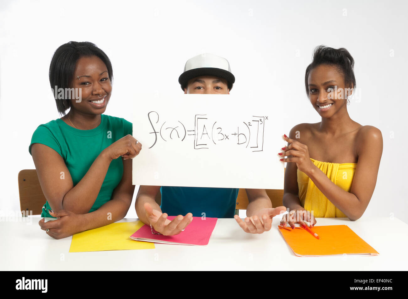 Two young woman holding a sign with a math equation on it Stock Photo