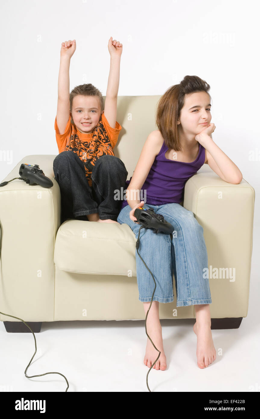 Siblings playing video game Stock Photo